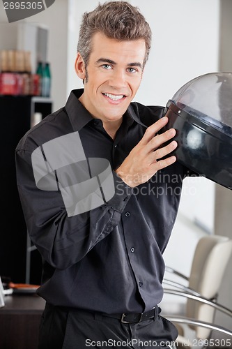 Image of Male Hairstylist With Steamer At Salon