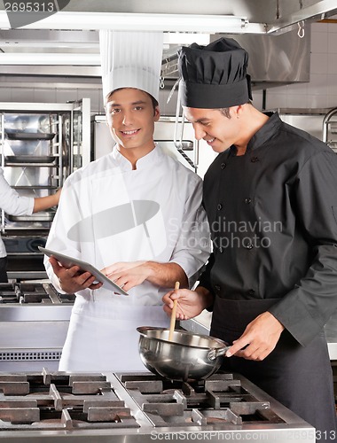 Image of Chefs With Digital Computer Cooking Food