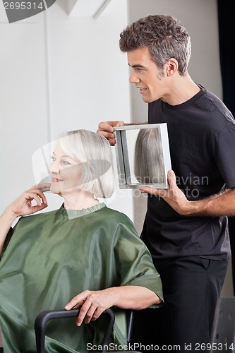 Image of Hairstylist Showing Finished Haircut To Customer