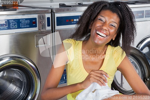 Image of Cheerful Woman With Clothes In Laundry