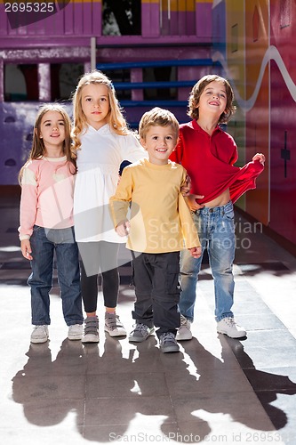 Image of Boy Standing With Friends In Kindergarten