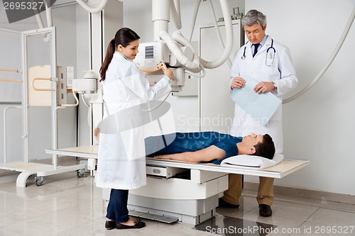 Image of Radiologists With Patient In X-ray Room