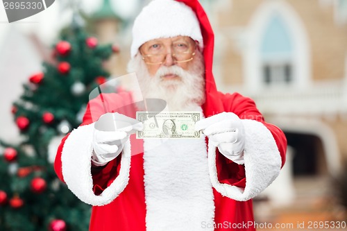 Image of Santa Claus Showing One Dollar Note