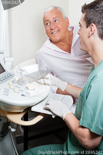 Image of Radiologic Technologist With Patient