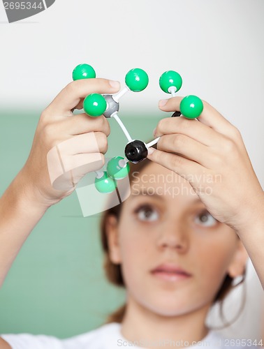 Image of Teenage Schoolgirl Examining Molecular Structure