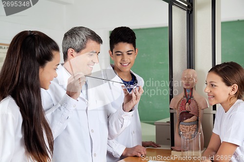 Image of Teacher With Teenage Students Experimenting In Lab