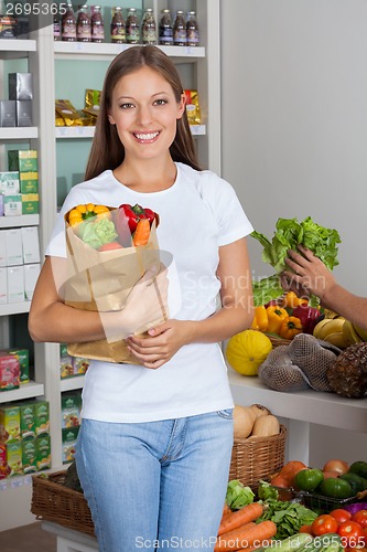 Image of Young Woman With Vegetable Bag