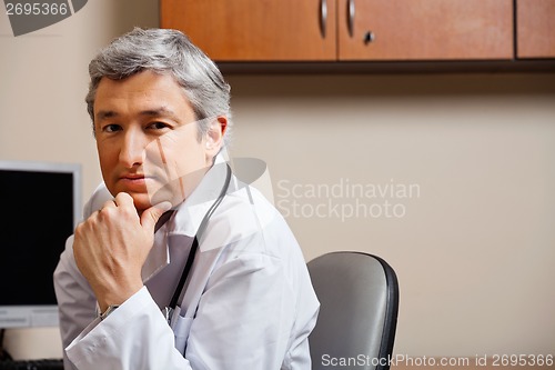 Image of Serious Doctor With Hand On Chin