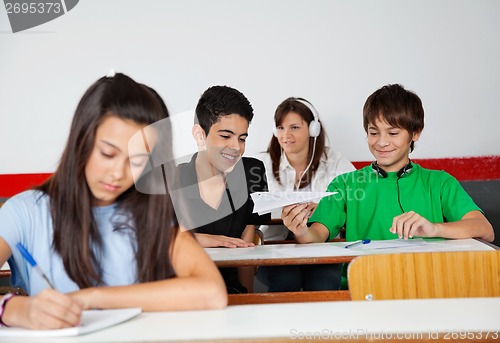 Image of Schoolboys Playing With Paperplane In Classroom