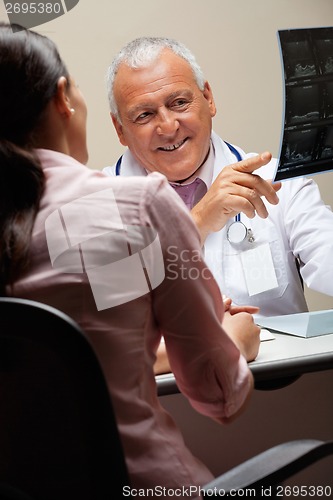 Image of Radiologist Showing X-ray To Patient