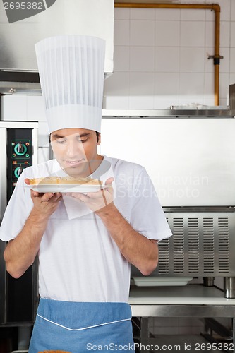 Image of Chef Smelling Sweet Dish In Kitchen