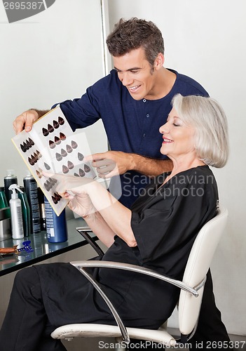 Image of Client And Hairdresser Selecting Hair Color From Catalog