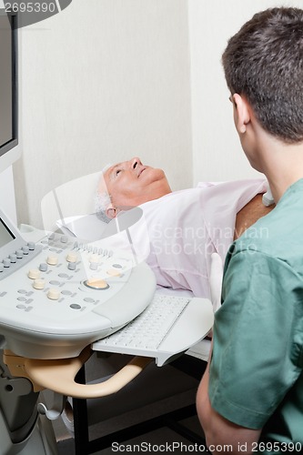 Image of Senior male abdomen ultrasound in clinic