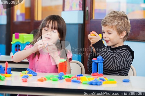 Image of Children Playing With Blocks In Classroom