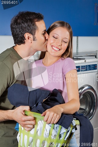 Image of Man Kissing Woman On Cheek At Laundromat