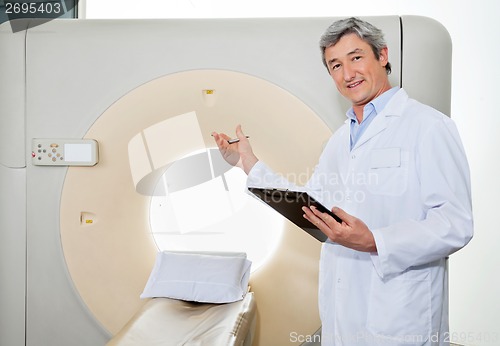 Image of Male Doctor Presenting The CT Scan Machine