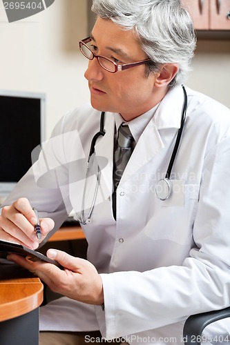 Image of Mature Male Doctor In Clinic