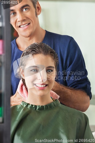 Image of Male Hairdresser Wiping Client's Hair