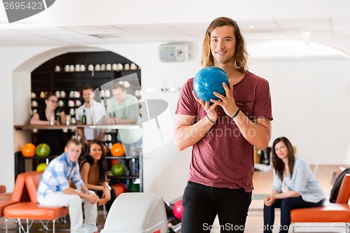 Image of Man Ready With Bowling Ball in Club