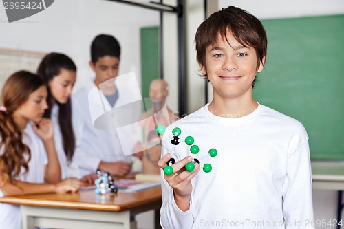 Image of Teenage Schoolboy Holding Molecular Structure In Biology Class