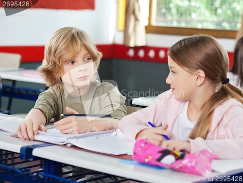 Image of Schoolchildren Looking At Each Other In Classroom