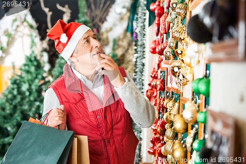 Image of Man Selecting Christmas Ornaments