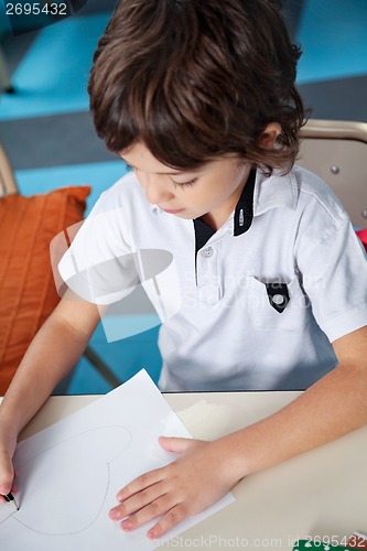 Image of Boy Drawing With Pencil On Paper In Art Class