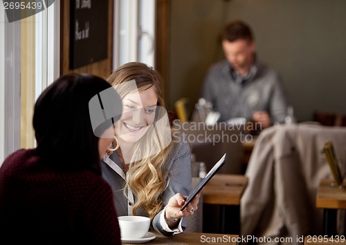 Image of Woman Showing Digital Tablet to Friend
