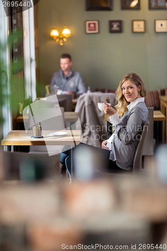 Image of Pregnant Woman Drinking Coffee At Cafe