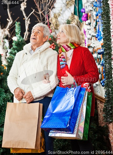 Image of Senior Couple Shopping In Christmas Store