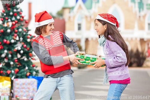 Image of Friends Pulling Christmas Gift