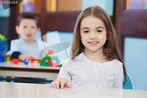 Image of Girl With Friend In Background At Preschool