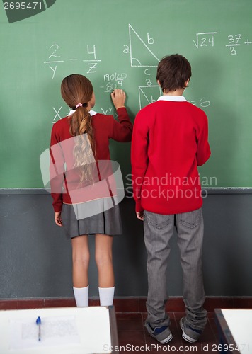 Image of Teenage Schoolchildren Writing On Board