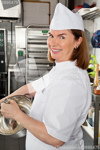 Image of Female Chef Mixing Egg In Container