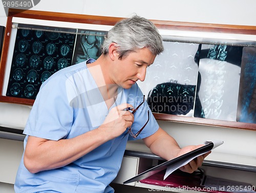 Image of Medical Professional Reading Document