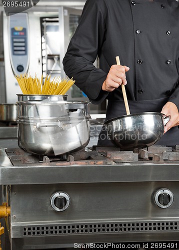 Image of Male Chef Preparing Spaghetti