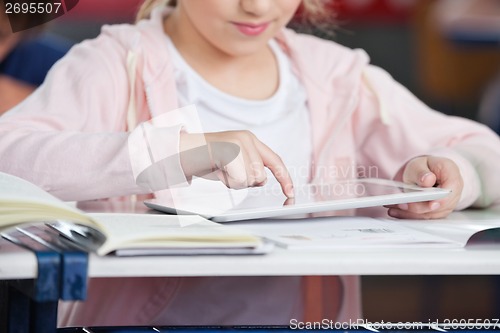 Image of Midsection Of Schoolgirl Using Tablet At Desk