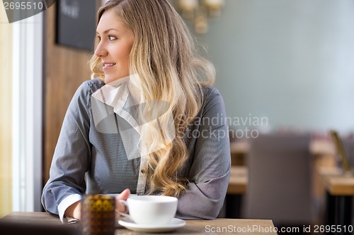 Image of Woman With Coffee Cup At Coffeeshop