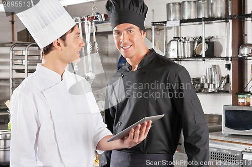 Image of Chef With Colleague Holding Digital Tablet