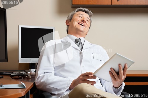 Image of Cheerful Doctor Holding Digital Tablet