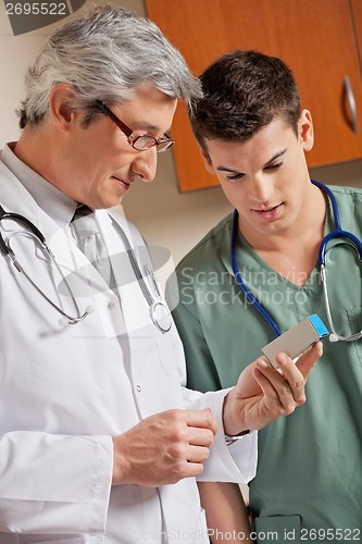 Image of Medical Professionals Looking At Medicine Box