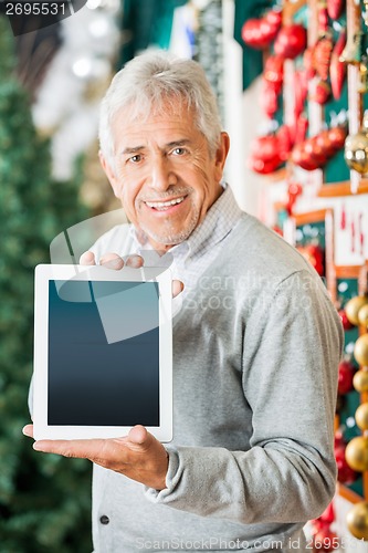 Image of Man Displaying Digital Tablet In Christmas Store