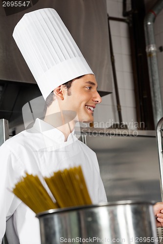 Image of Young Male Chef Standing In Kitchen