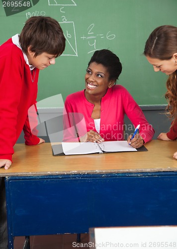 Image of Teenage Students With Teacher At Desk In Classroom