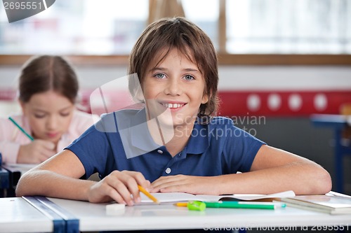 Image of Cute Schoolboy Smiling In Classroom