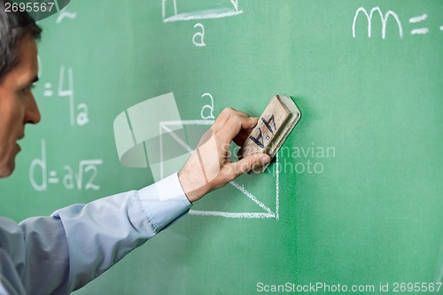 Image of Male Professor Cleaning Greenboard With Duster