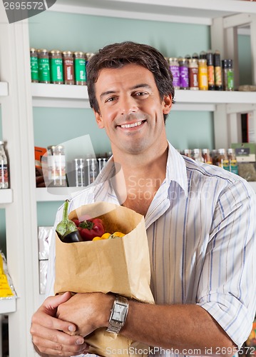 Image of Man With Vegetable Bag In Grocery Store