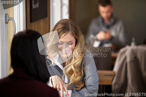 Image of Female Friends Having Coffee At Cafe