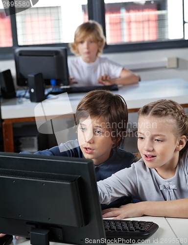 Image of Little Schoolchildren Looking At Computer Monitor