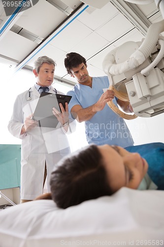 Image of Technician Setting Up Machine To X-ray Patient